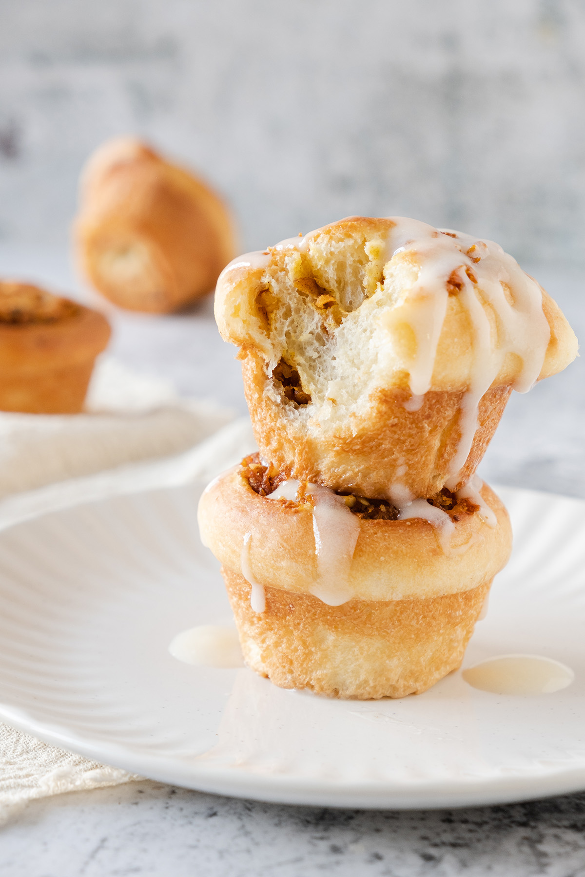 Two carrot cake cruffins stacked on top of each other.