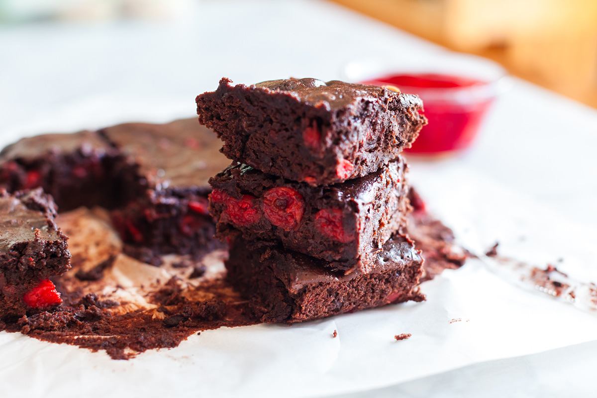 A stack of three chocolate cherry brownies.