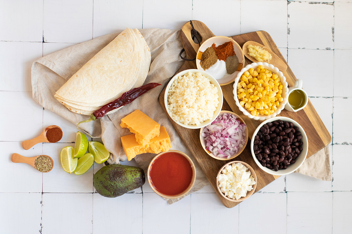 Ingredients for rice and bean enchiladas on the counter. 