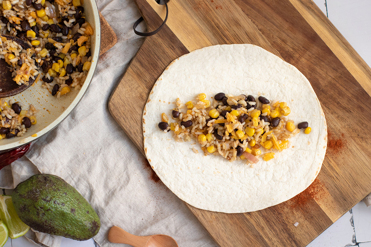 Bean and rice filling in the middle of a tortilla.