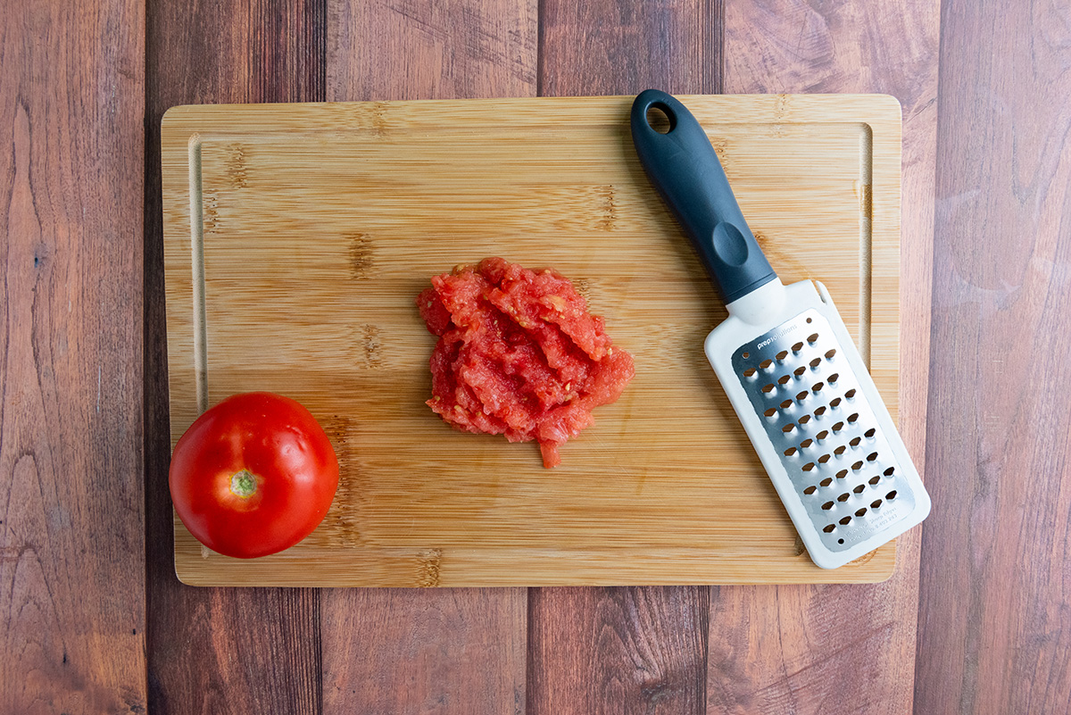 Grated tomato on a cutting board.