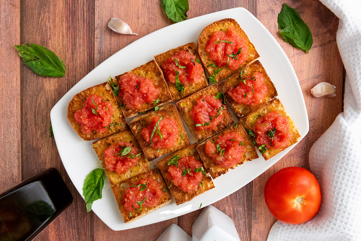 Tomato toast on a white serving platter.