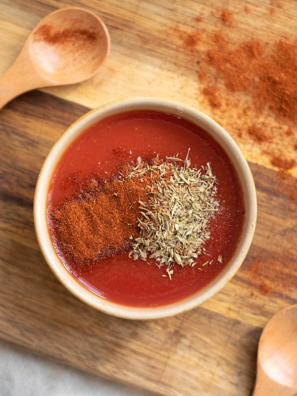 Making a quick enchilada sauce with marinara and spices.