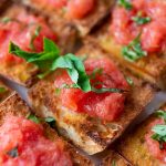 Slices of Spanish pan con tomate on counter.