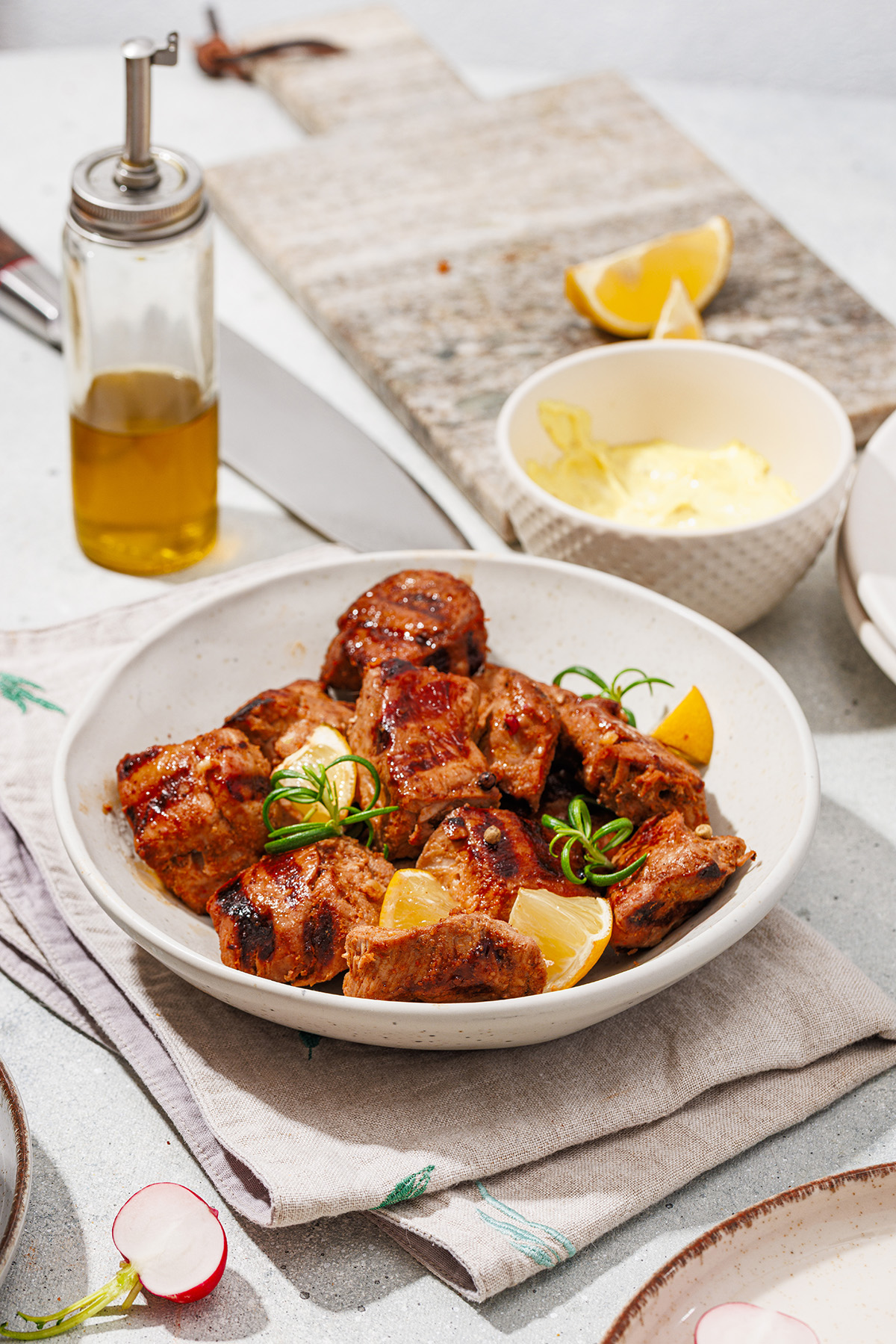 Char-grilled pork skewers stacked on a plate with visible grill marks, perfect for summer BBQs.