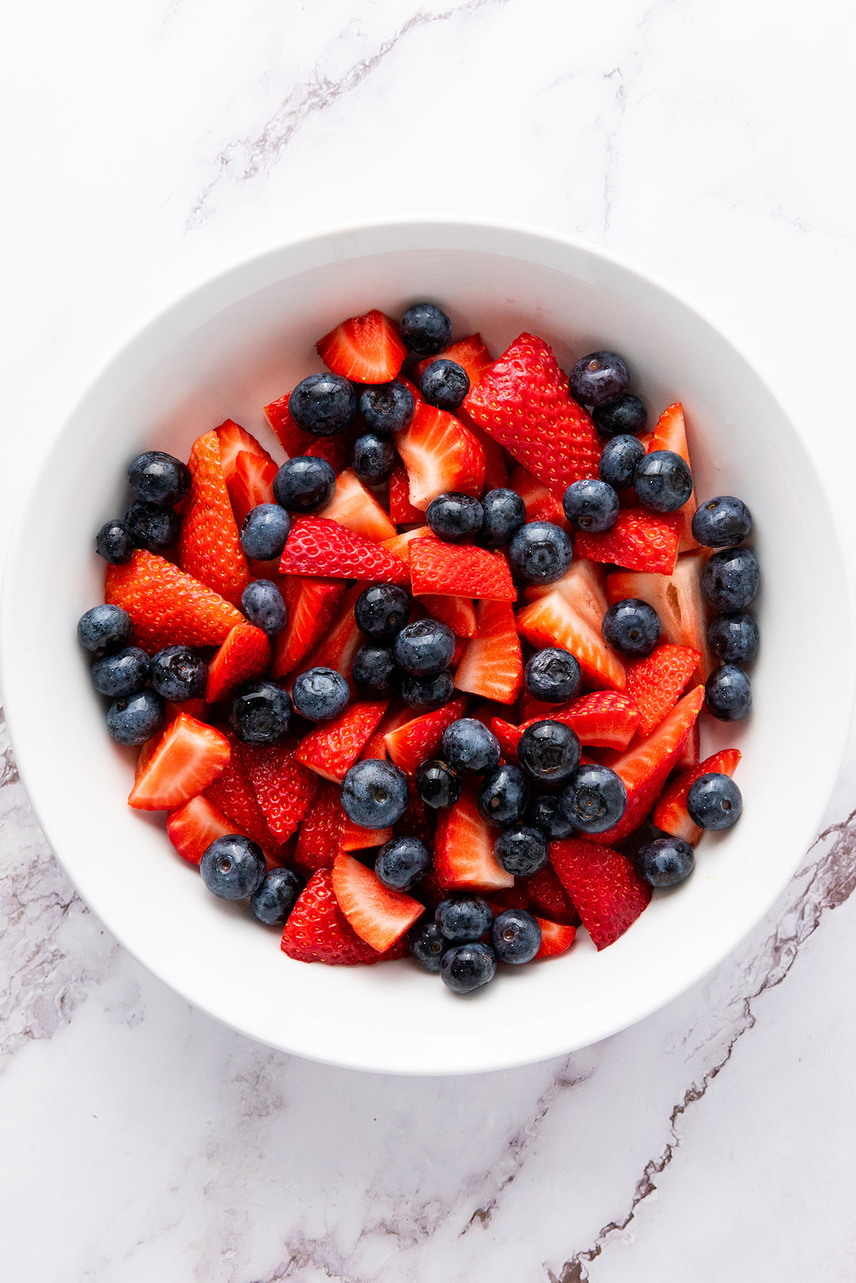 Bowl of strawberries and blueberries, the base of a 4th of July fruit salad.