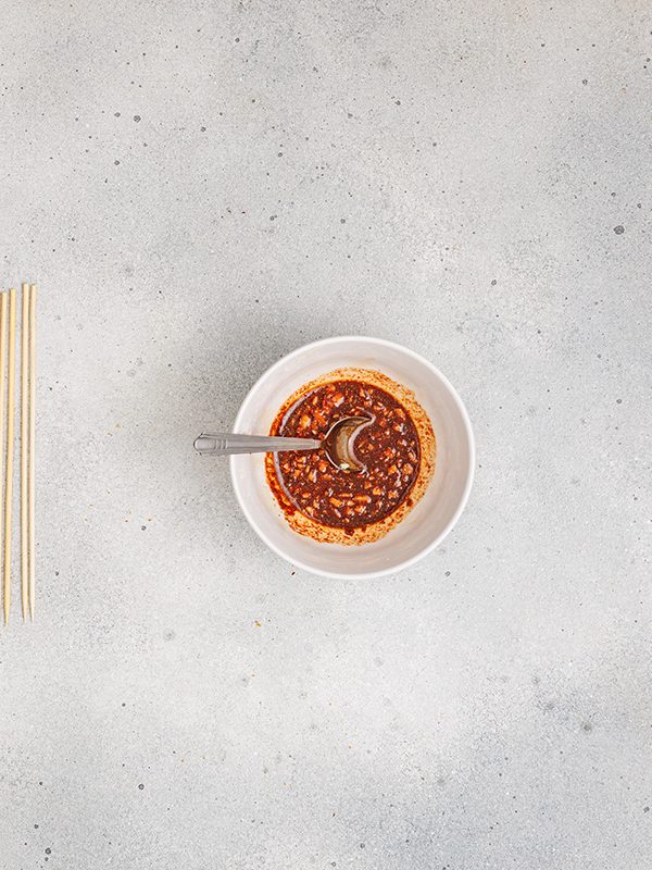 Overhead view of marinade ingredients being stirred ina. bowl.