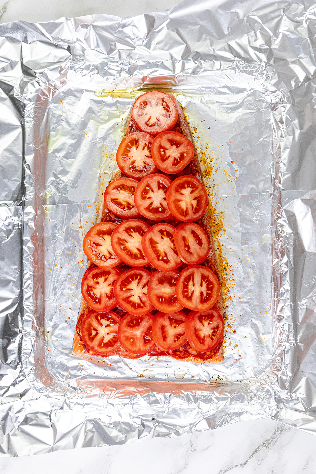 Salmon topped with chorizo then tomato slices.