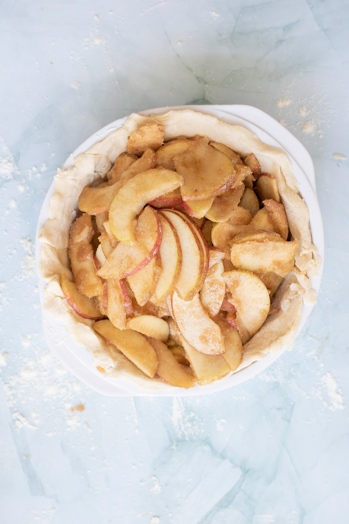 Pie crust filled with sliced Honeycrisp apples coated in cinnamon sugar