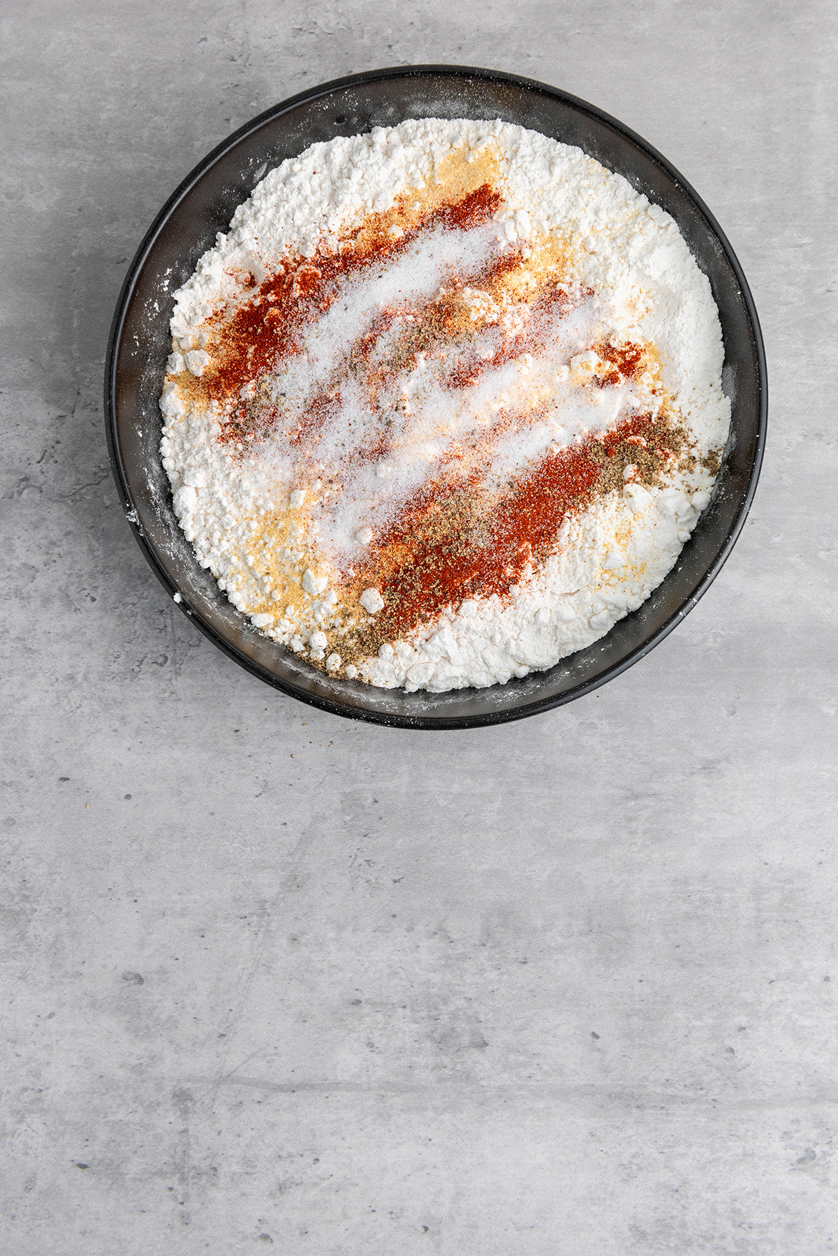Seasoned flour mixture with paprika, garlic powder, onion powder, salt, and pepper.