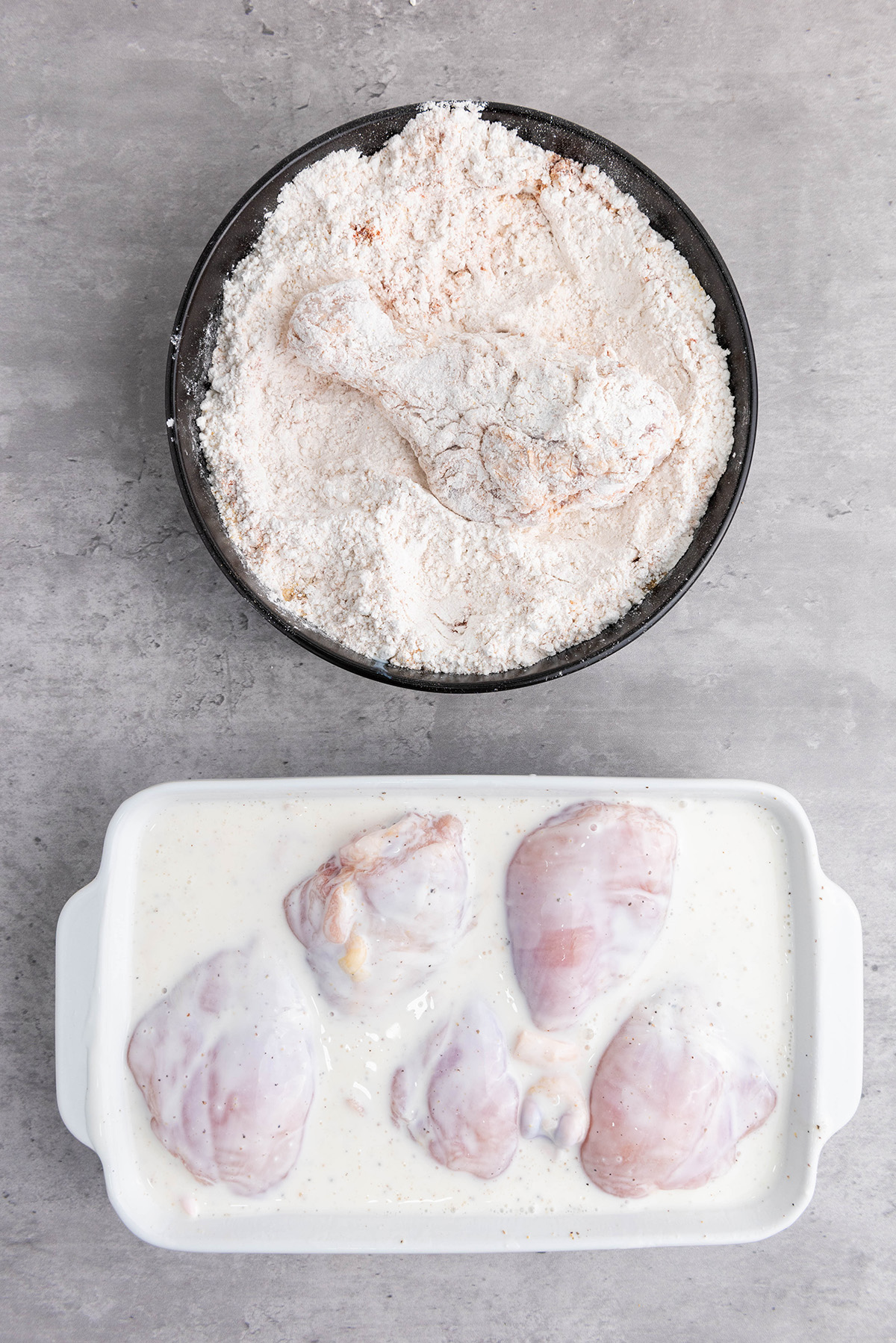 Chicken drumsticks marinating in seasoned buttermilk.