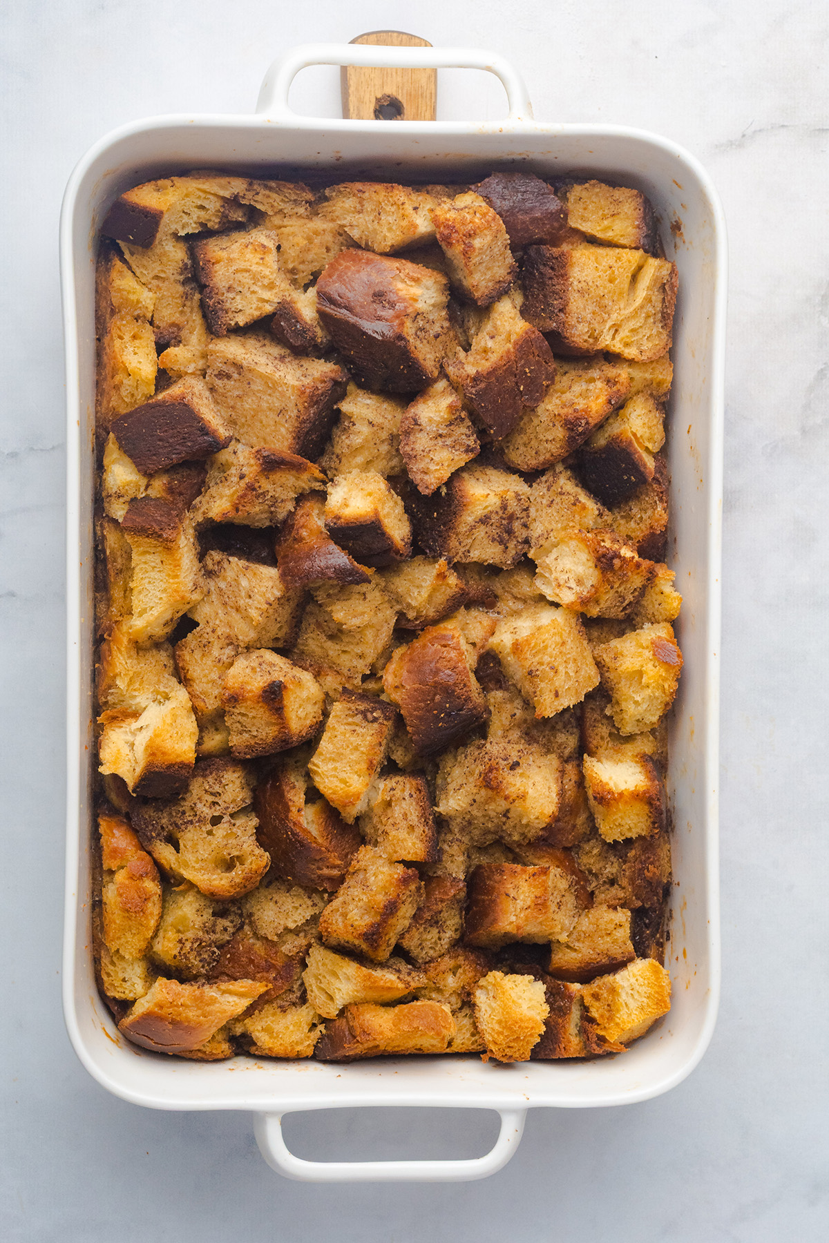 With rich molasses, warm spices, and a crunchy topping, this gingerbread French toast casserole is an easy, crowd-pleasing breakfast for Christmas morning. Gingerbread French toast casserole fresh from the oven, baked until golden and puffed with crisp edges.