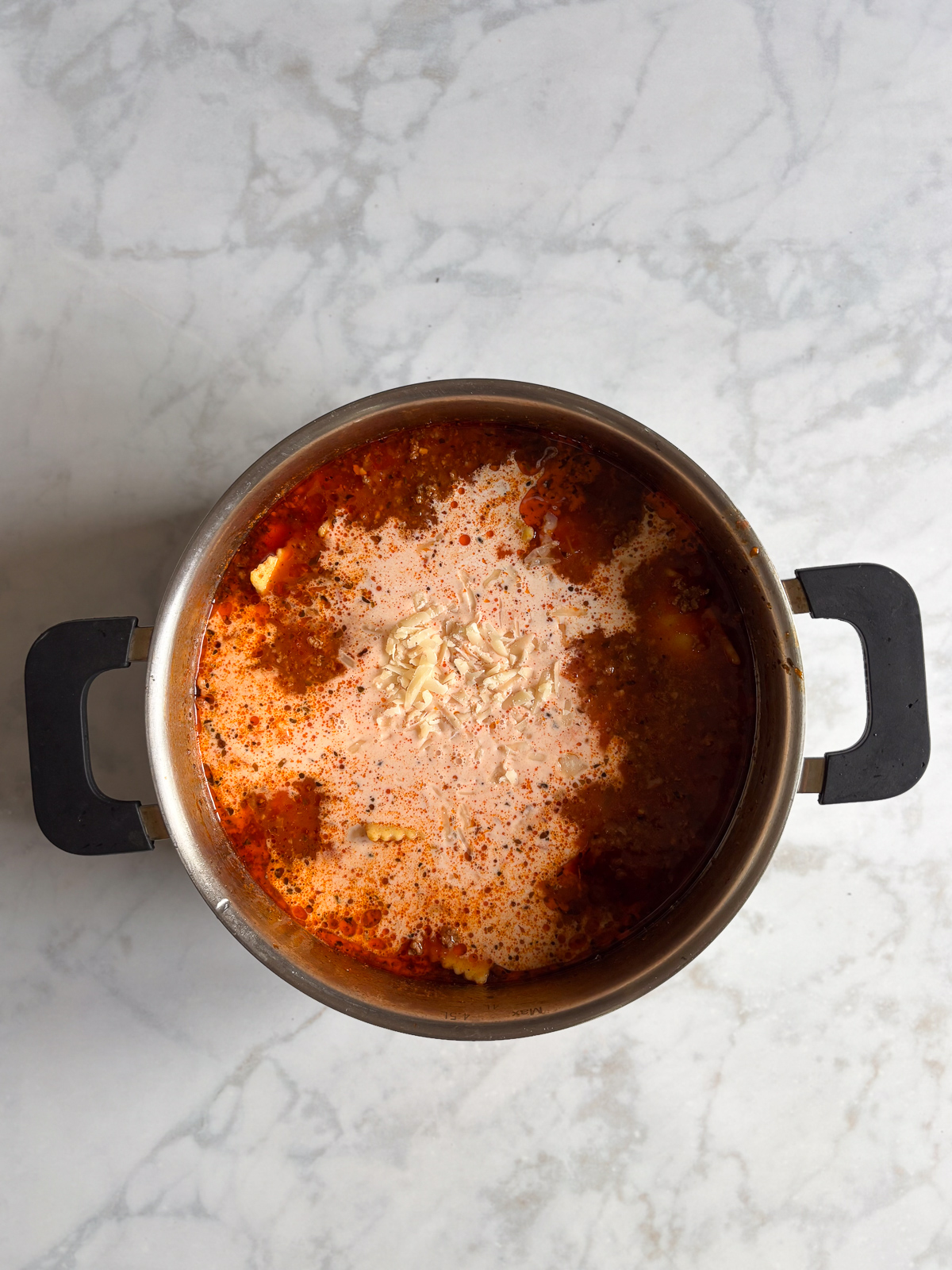 This million dollar ravioli soup is a cozy bowl of cheesy ravioli, rich tomato sauce, and tender ground beef. Simple ingredients come together in one pot, making it perfect for easy weeknight dinners. Heavy cream and grated Parmesan cheese poured into the simmering ravioli soup for a rich, creamy finish.