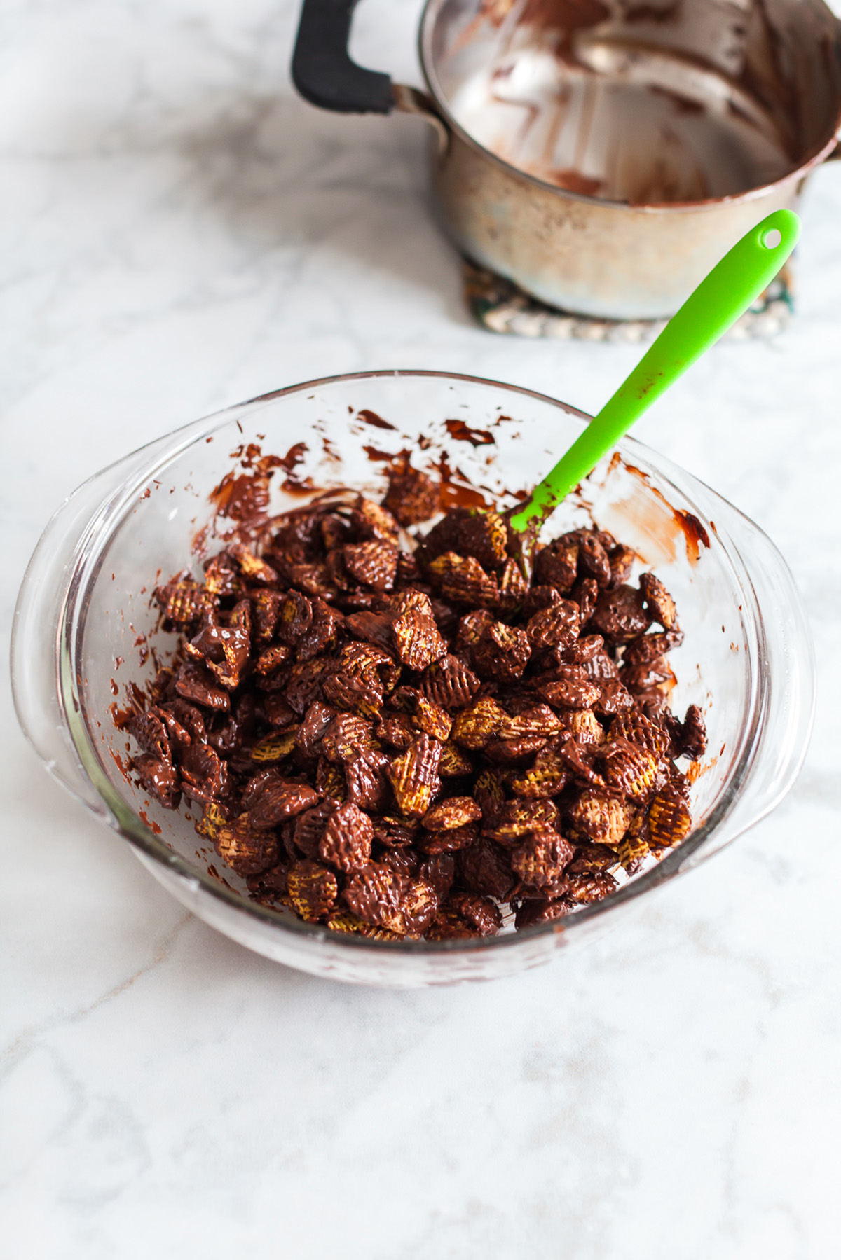 Melted chocolate and peanut butter stirred until smooth for puppy chow recipe.
