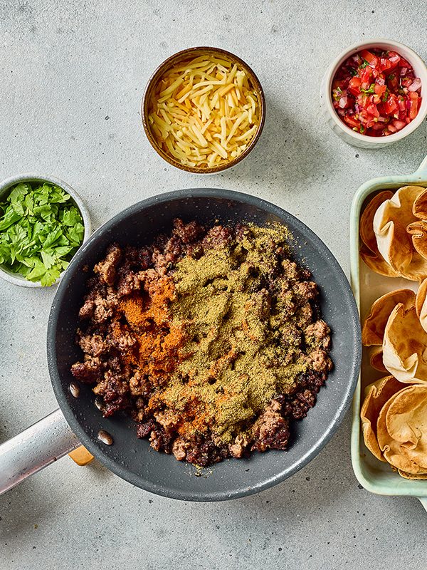 Ground beef cooking in a skillet with taco seasoning and ranch seasoning before assembling taco ranch bites.