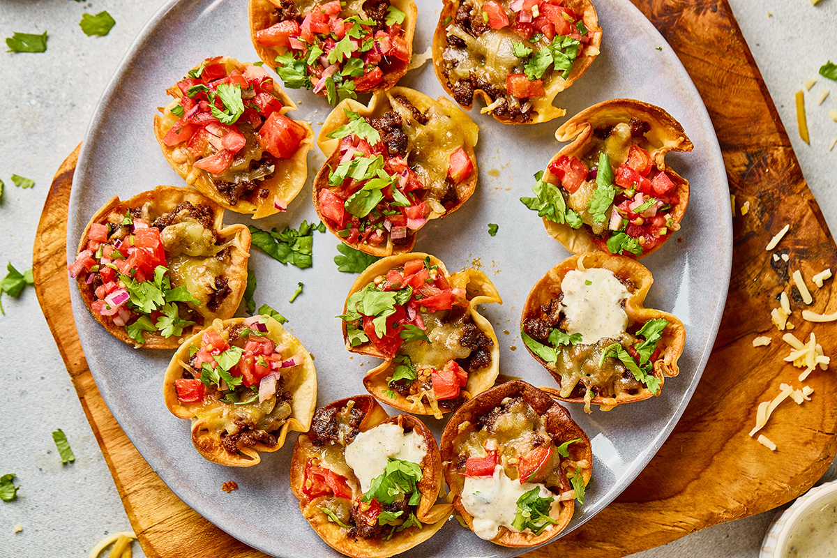 Finished taco ranch bites garnished with fresh cilantro and diced tomatoes on a serving plate.