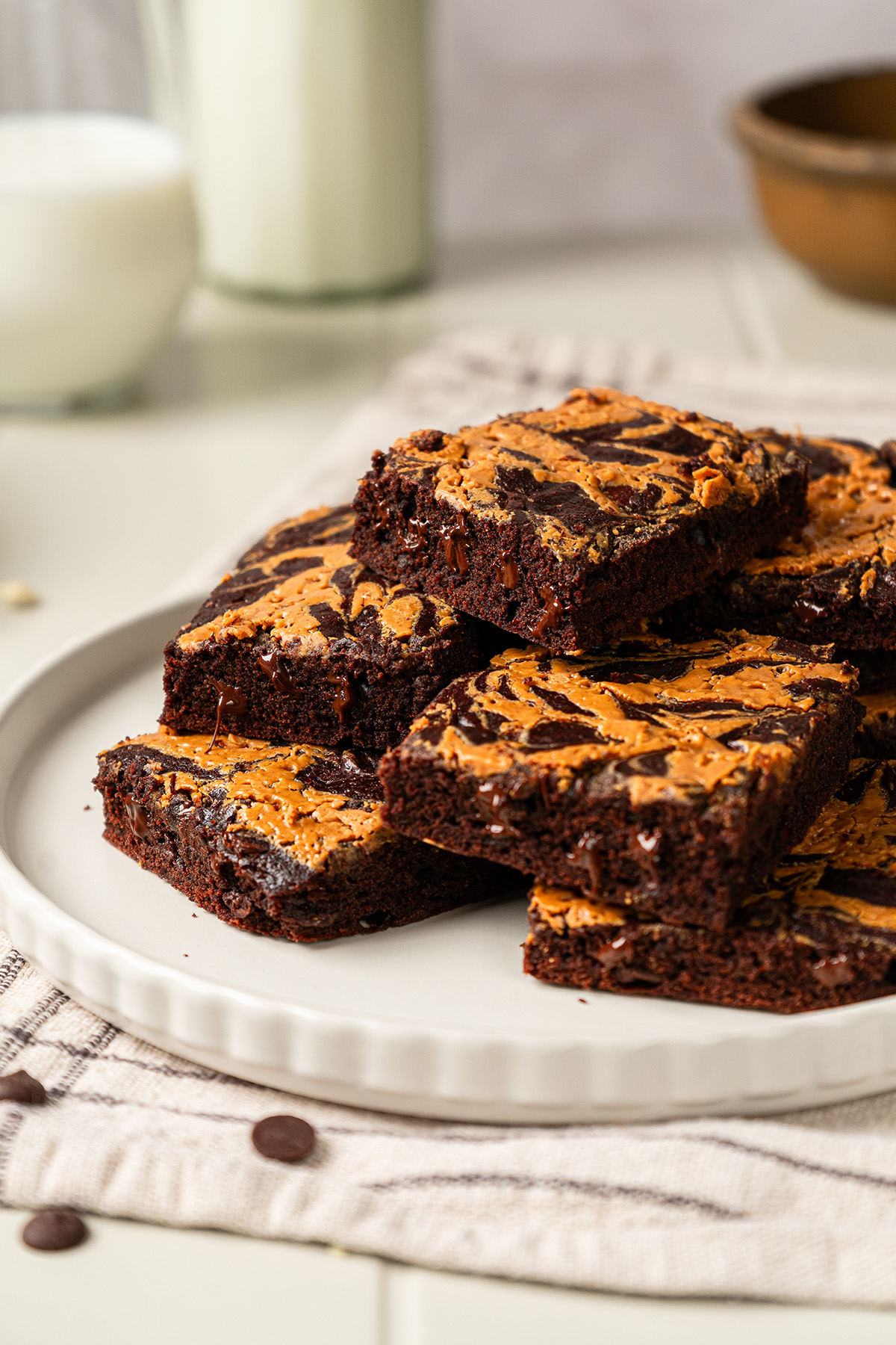 Stacked squares of chocolate peanut butter swirl brownies with gooey chocolate chips and peanut butter swirl.