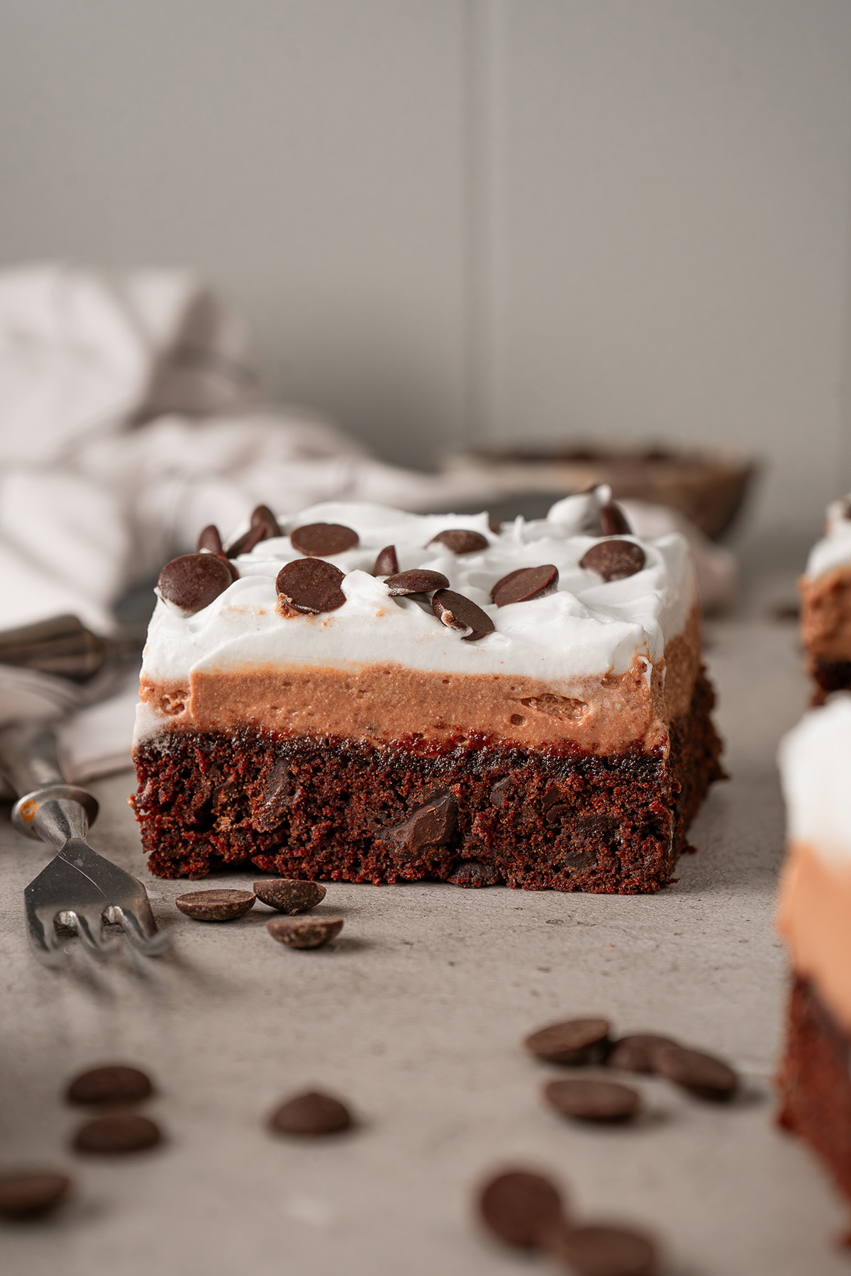 French silk brownies made with brownie mix showing a fudgy brownie base topped with a creamy chocolate silk layer and whipped topping.