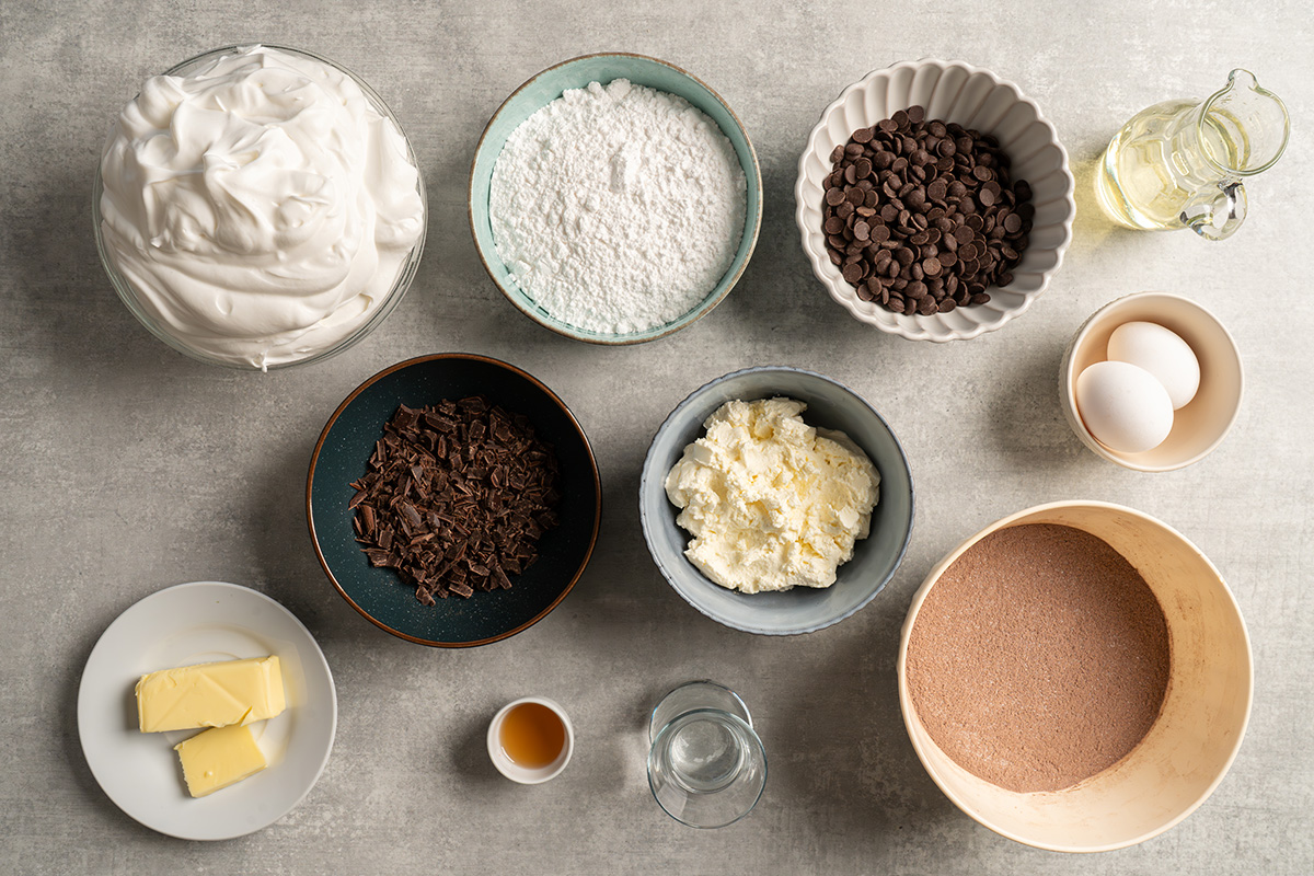 Ingredients for French silk brownies with brownie mix, including brownie mix, cream cheese, powdered sugar, chocolate, butter, eggs, oil, and whipped topping.