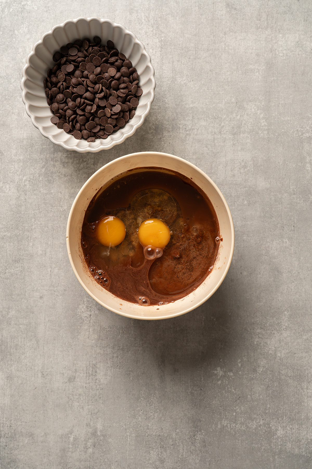 Brownie mix batter with eggs added in a mixing bowl, ready to be stirred for French silk brownies.
