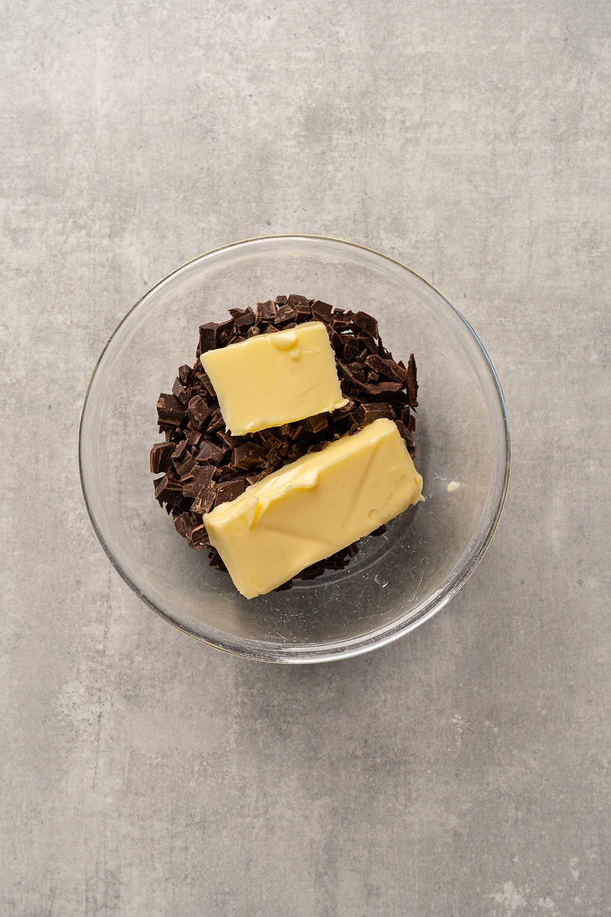 Chopped chocolate and butter in a glass bowl before melting for the French silk layer.