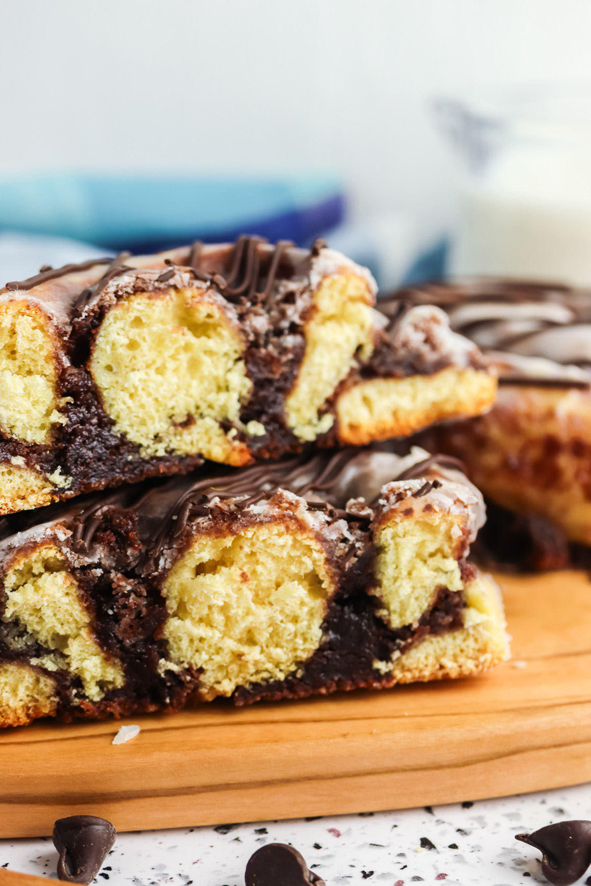 Sliced brownie cinnamon roll showing soft cinnamon dough layered with rich brownie filling and chocolate drizzle.