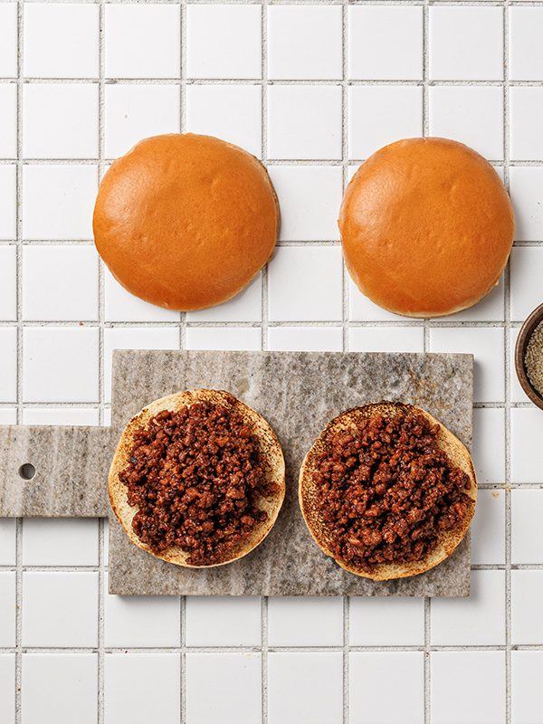 Korean ground beef spooned onto toasted buns before adding toppings.