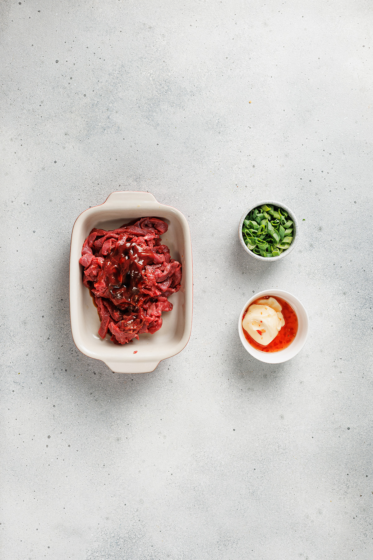 Raw sliced beef with sauce for bulgogi Korean loaded fries.