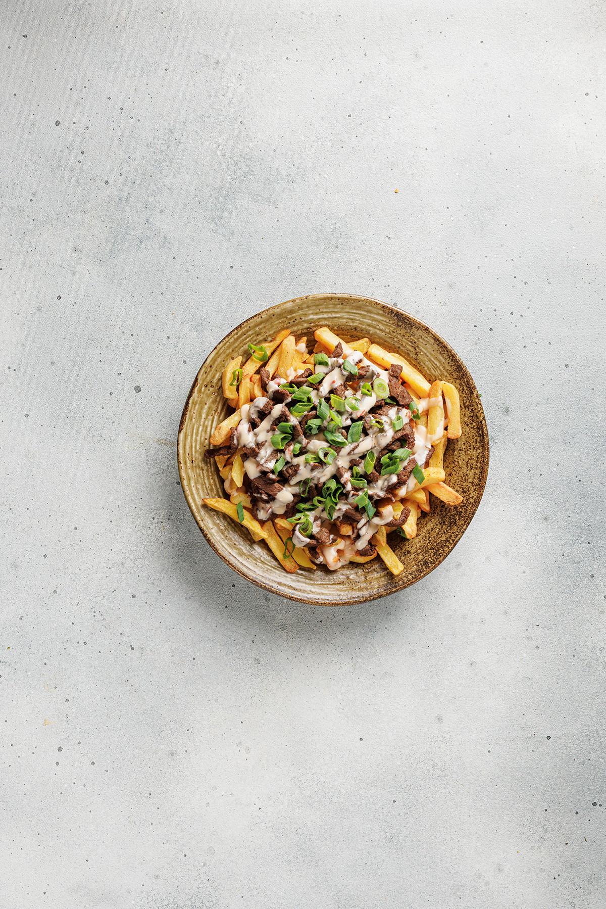 Cooked bulgogi beef layered over crispy fries for Korean loaded fries.