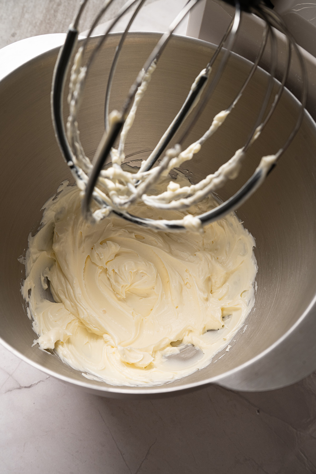 These cream cheese sugar cookies are soft, sweet, and topped with fluffy frosting. Starting with sugar cookie mix keeps them easy, but they still feel special enough for parties and holidays. Cream cheese frosting whipped until smooth and fluffy in a stand mixer bowl.