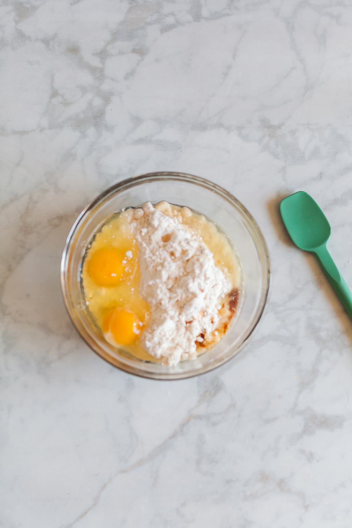 Vanilla cake mix, eggs, oil, and vanilla extract in a bowl before mixing into cookie dough.