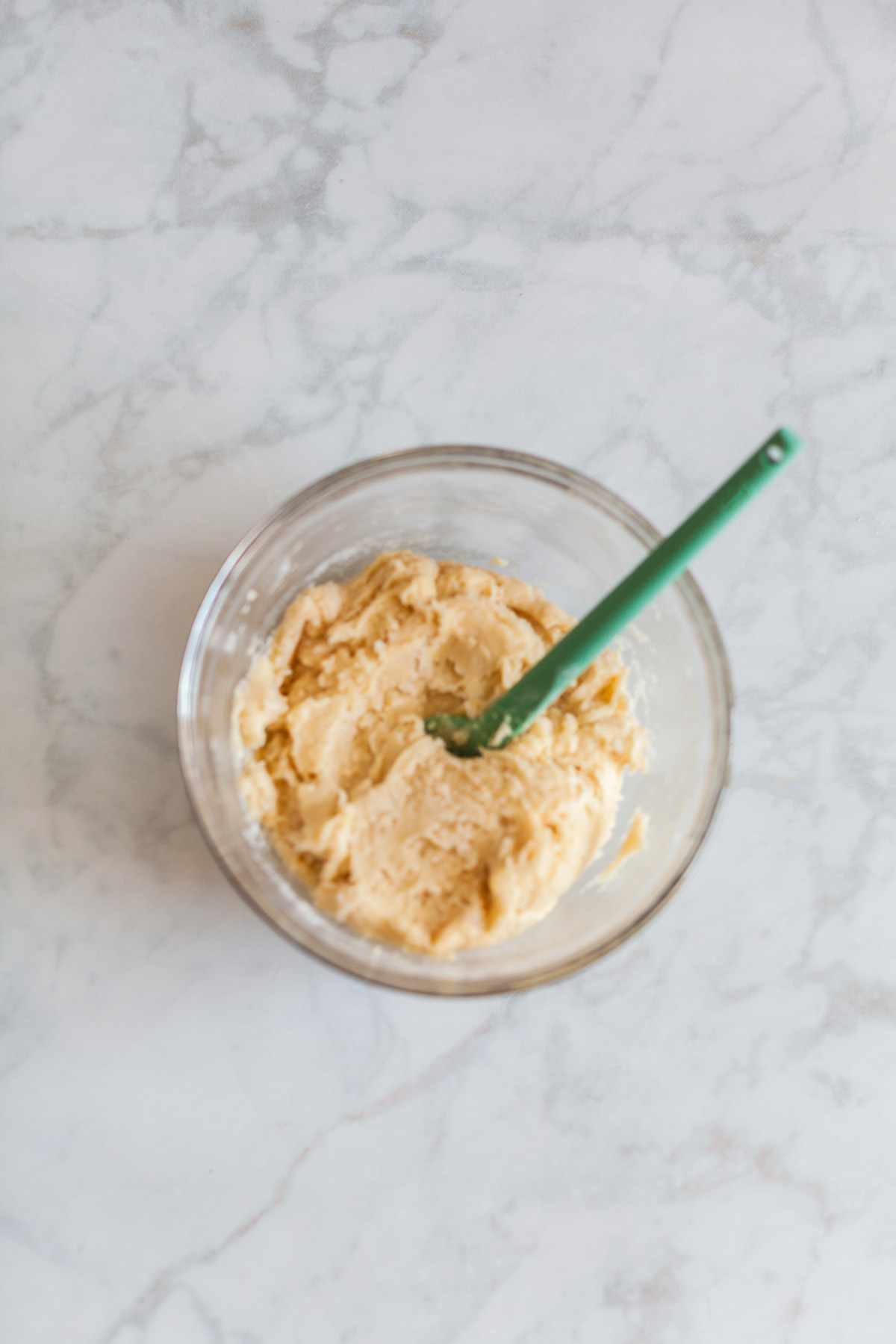 Soft vanilla cake mix cookie dough in a bowl.