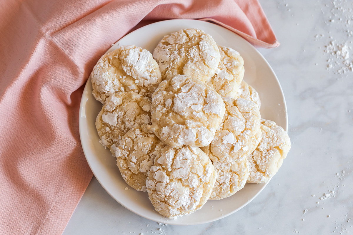 Soft vanilla crinkle cookies made with cake mix served on a plate with a light dusting of powdered sugar.