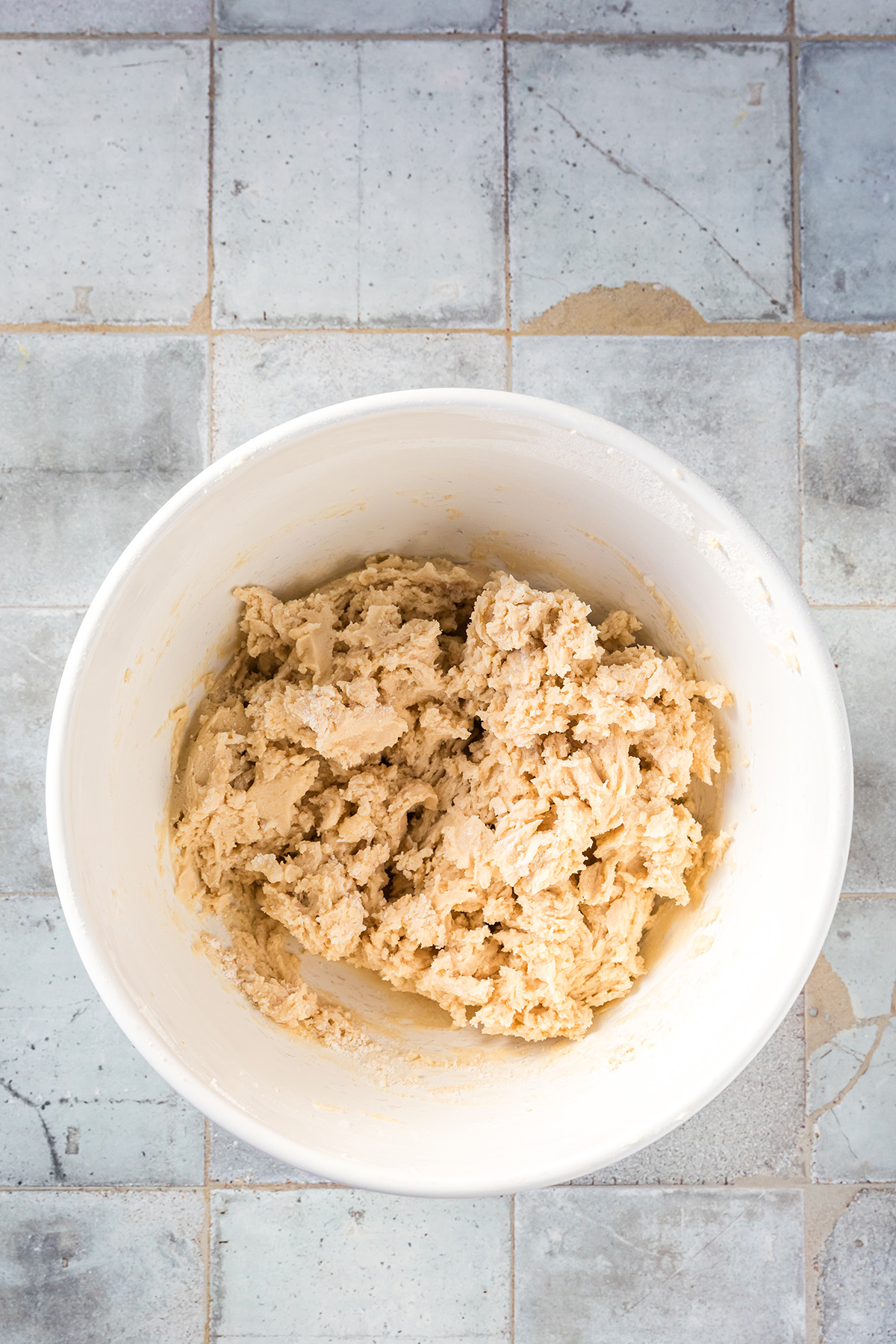 Cookie dough for strawberry snowball cookies mixed in a white bowl.