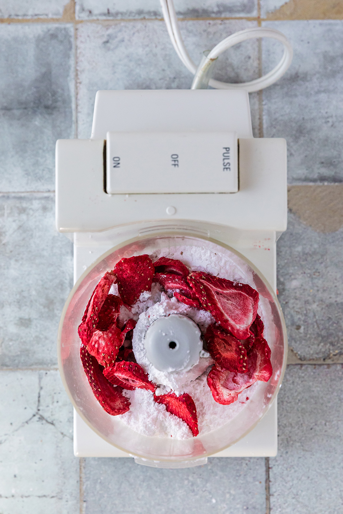 Freeze-dried strawberries and powdered sugar blended to make strawberry coating for pecan snowball cookies.