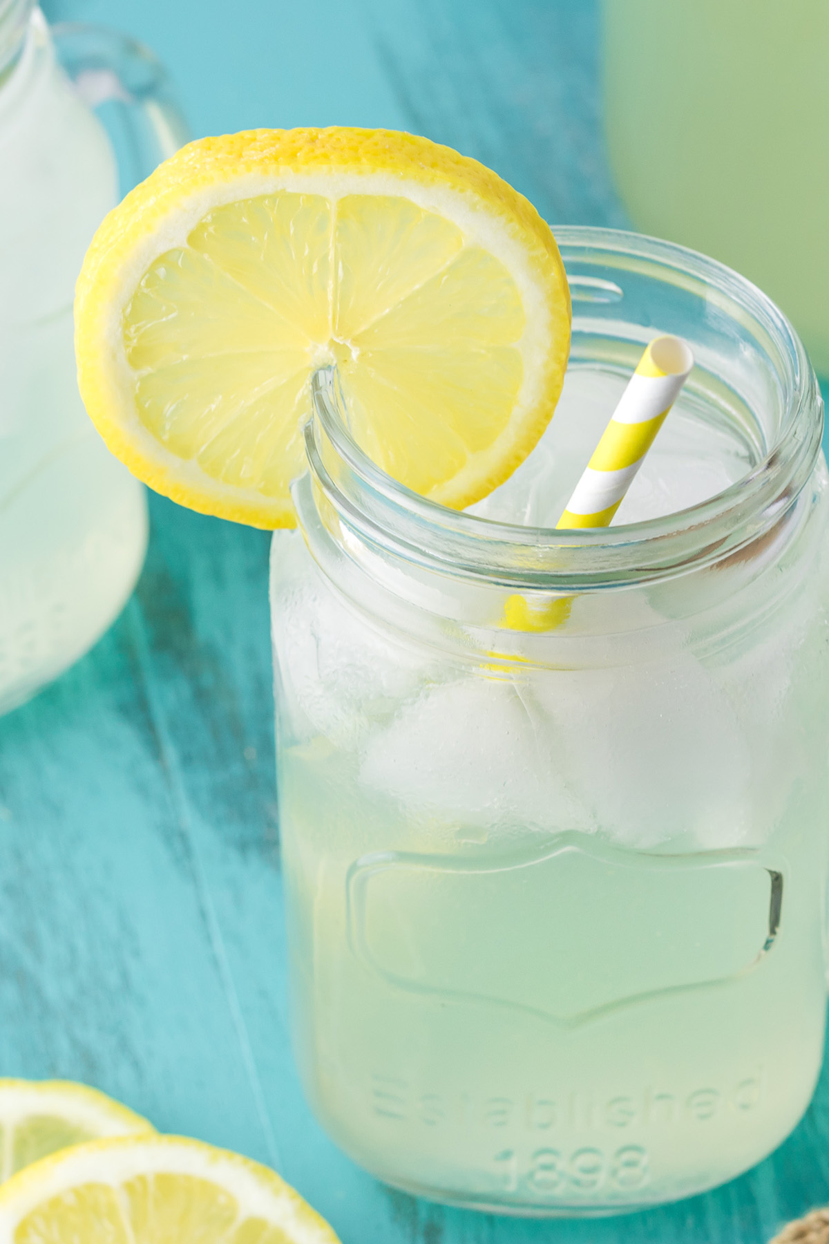 Close up of homemade hard lemonade with ice and fresh lemon garnish.