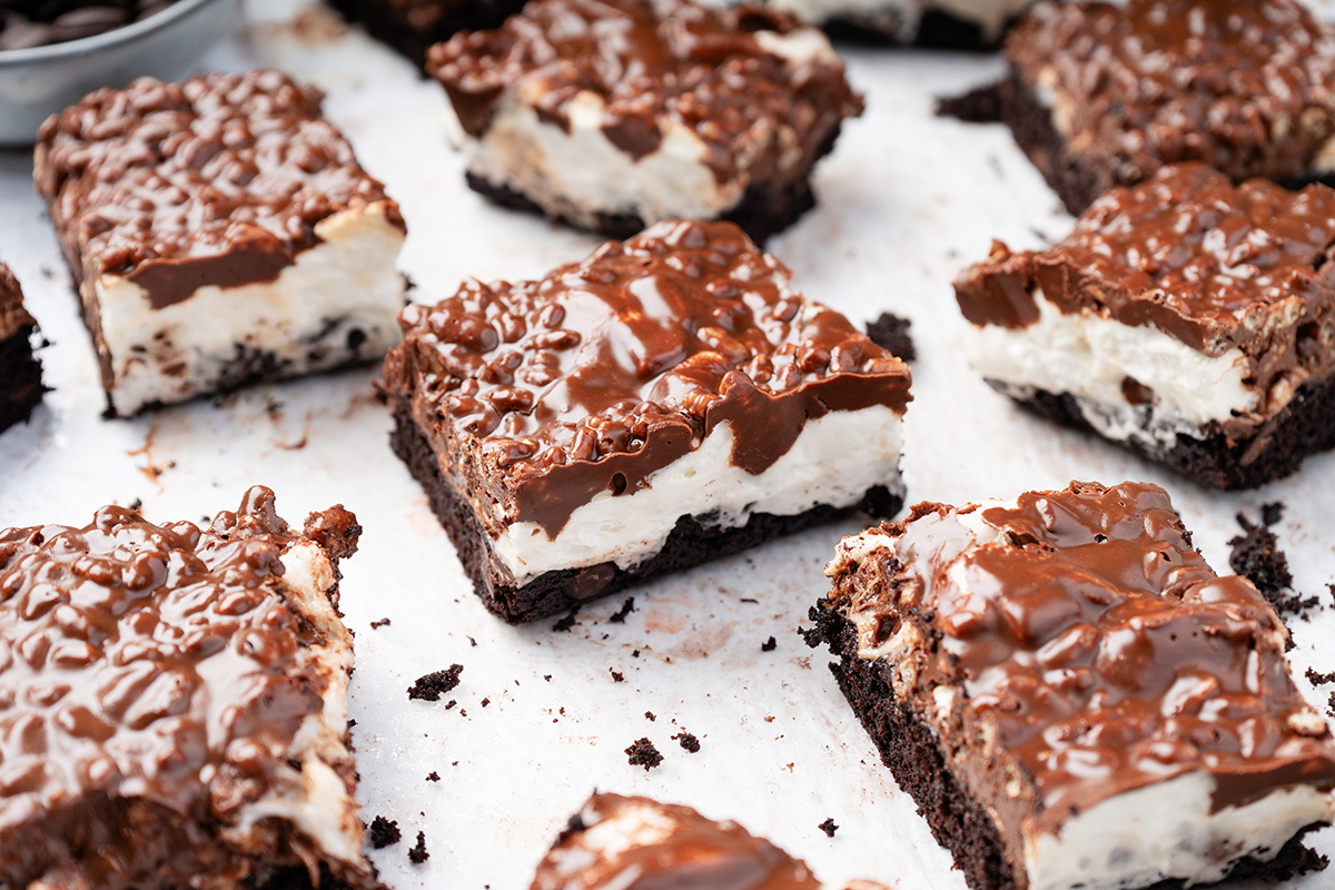 Chocolate and peanut butter rice krispie bars cut into squares with a gooey marshmallow layer and fudgy brownie bottom.