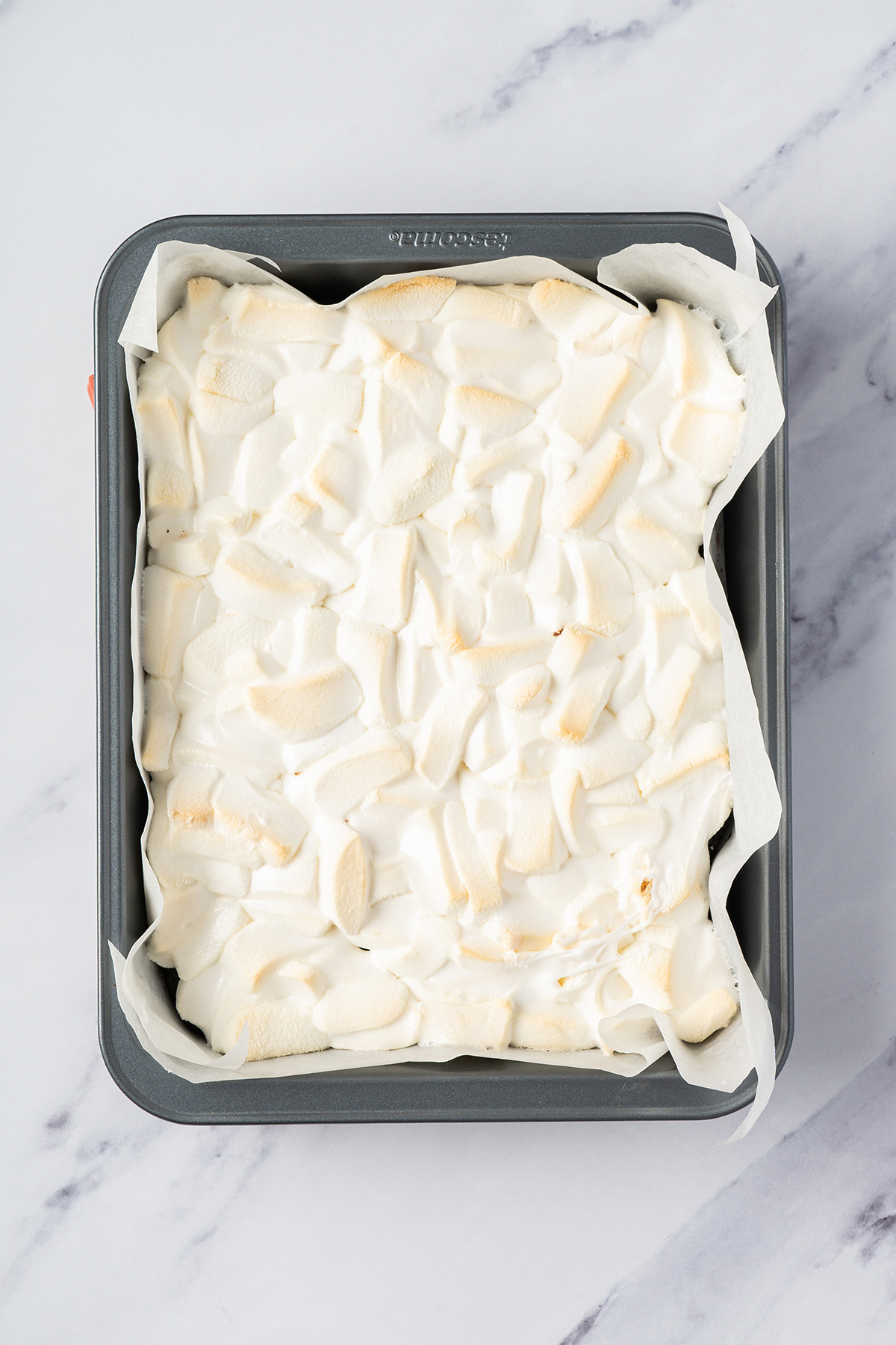 Soft, melted marshmallows baked on top of fudgy brownies for chocolate peanut butter rice krispie bars.