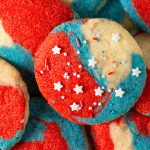 Close-up of baked red, white and blue 4th of July sugar cookies with star sprinkles.