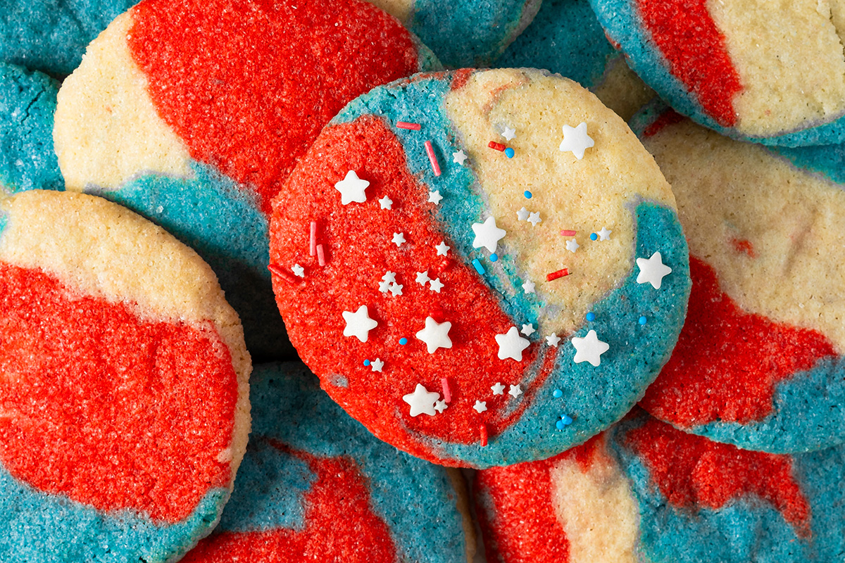 Close-up of baked red, white and blue 4th of July sugar cookies with star sprinkles.