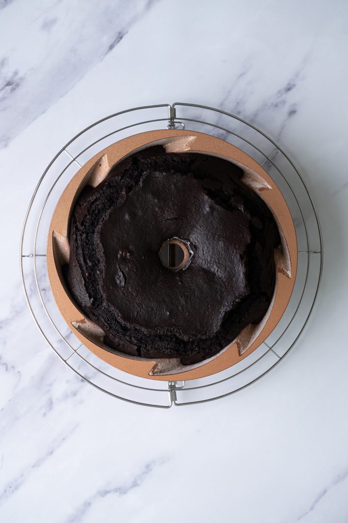 Baked chocolate brownie Bundt cake cooling in the pan before being turned out.
