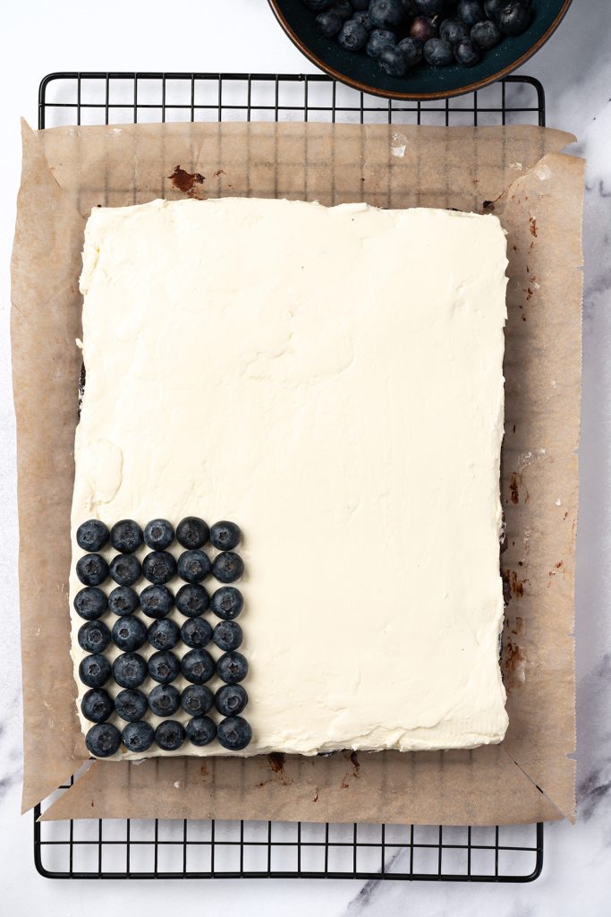 Blueberries arranged in rows on the frosted brownies for the flag design.