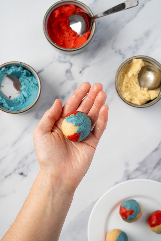 Red, white and blue patriotic sugar cookie dough rolled into a ball.