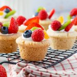 Close-up of fruit pizza cookie bites with strawberries, blueberries, kiwi, and mandarin oranges.