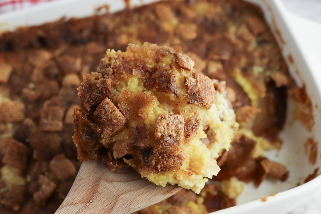 Close-up of a serving of Cinnamon Toast Crunch apple dump cake with apple filling and crunchy cinnamon cereal topping.