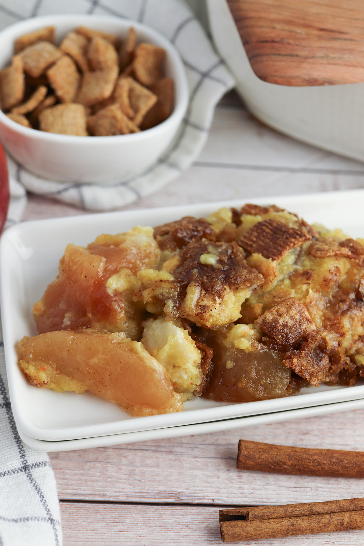 Cinnamon Toast Crunch apple dump cake served on a white plate with warm apple filling and cinnamon cereal topping.